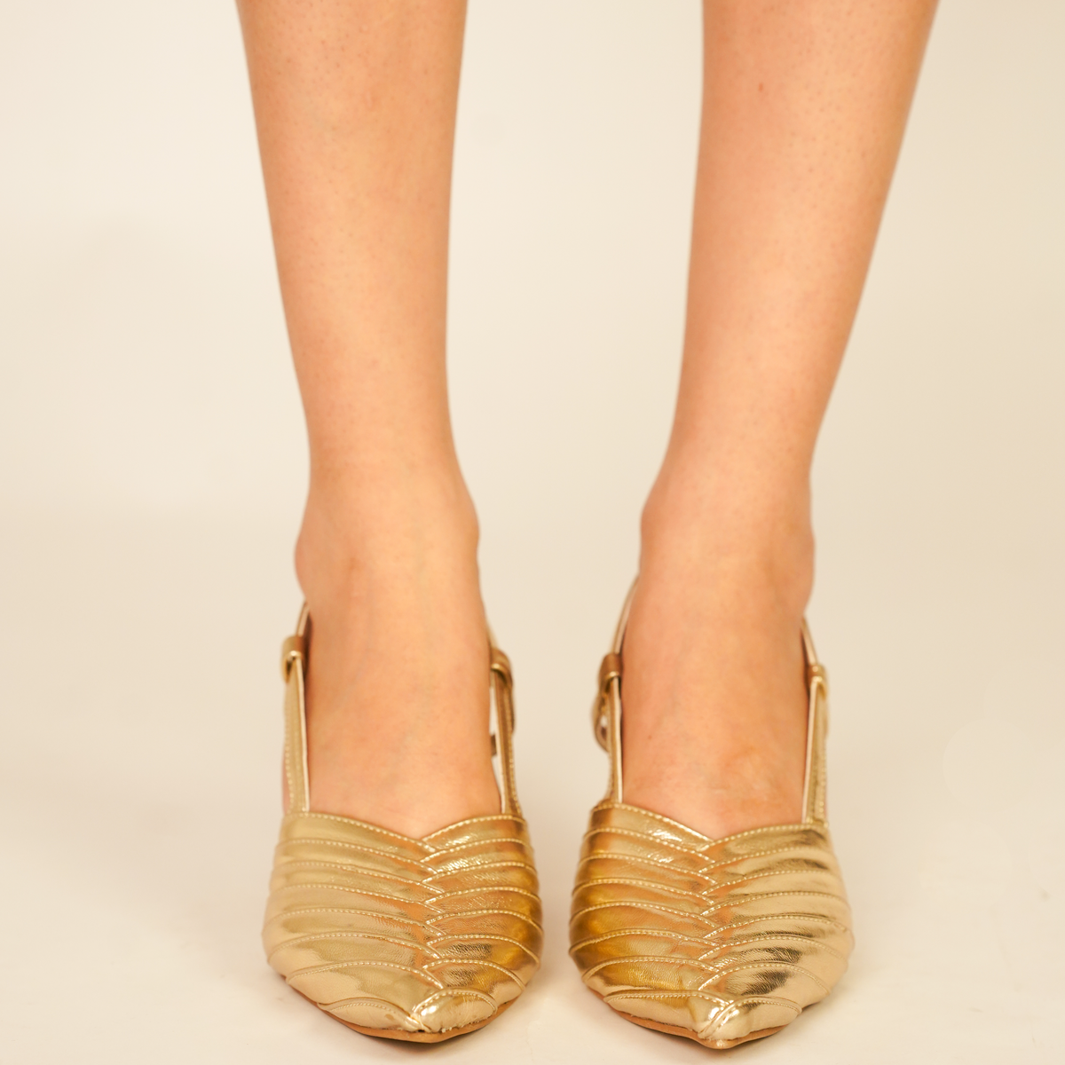 Smooth metallic gold pointed-toe vegan leather pencil heels with beige lining