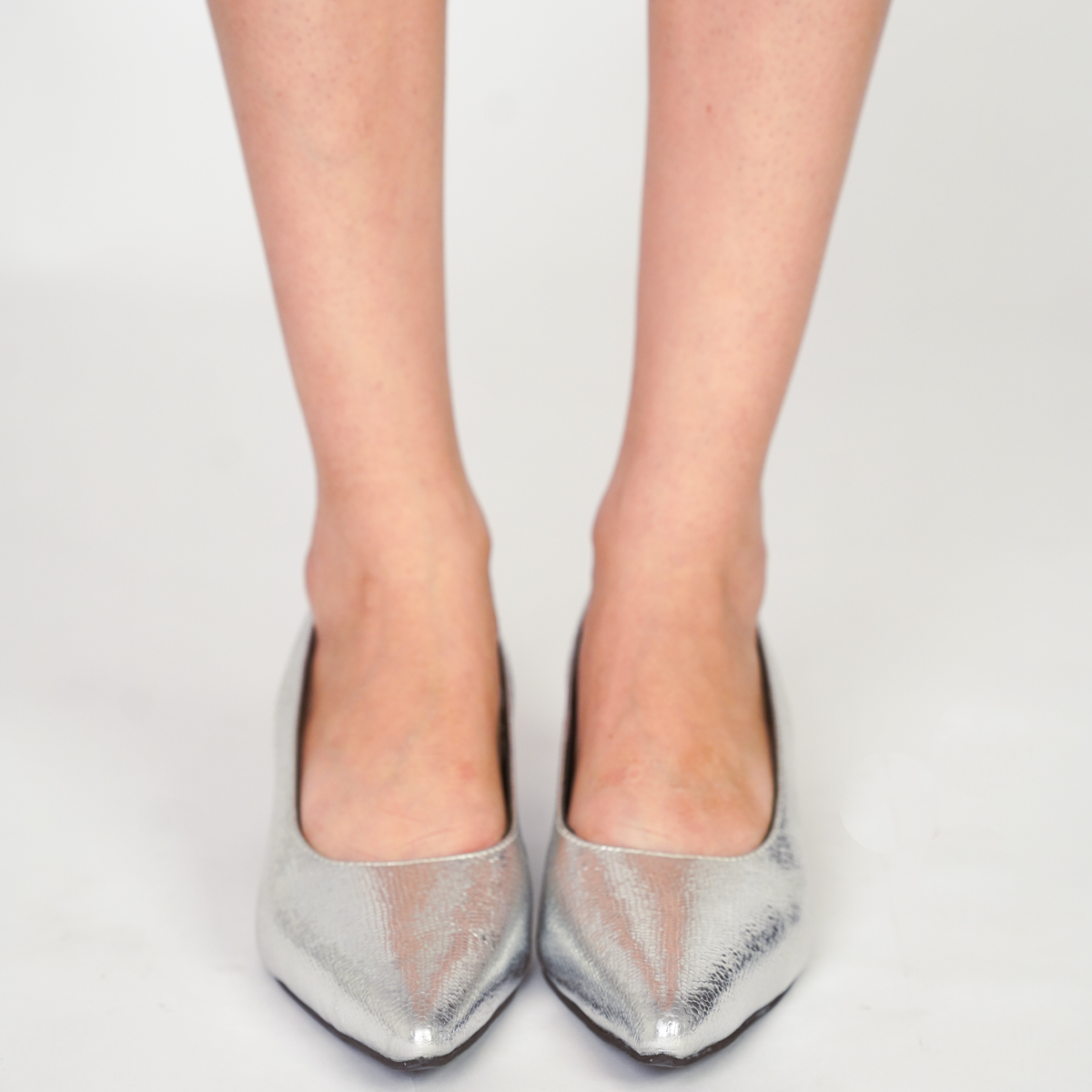 Embossed metallic silver pointed-toe vegan leather kitten heels with black lining