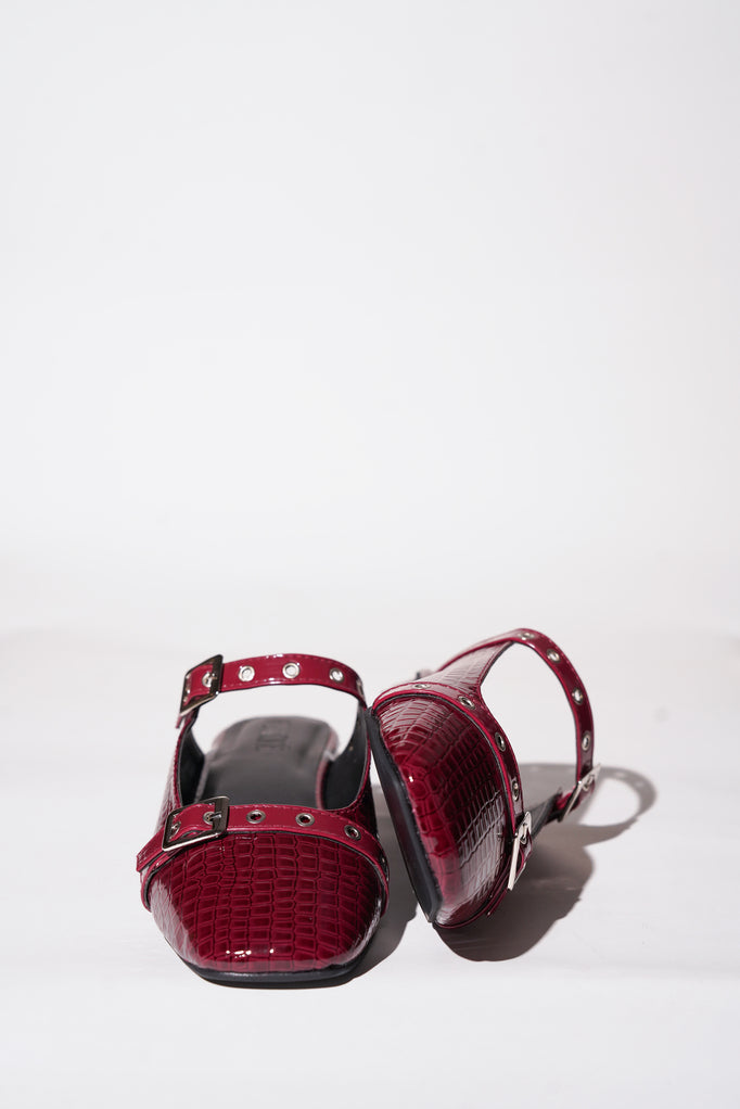Red croc-textured Mary Jane flats with silver buckle straps
