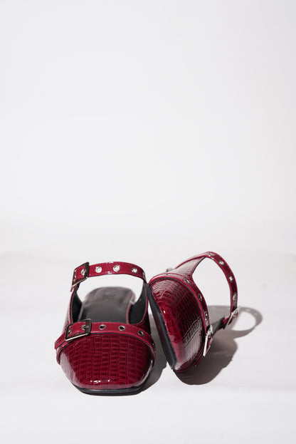 Red croc-textured Mary Jane flats with silver buckle straps